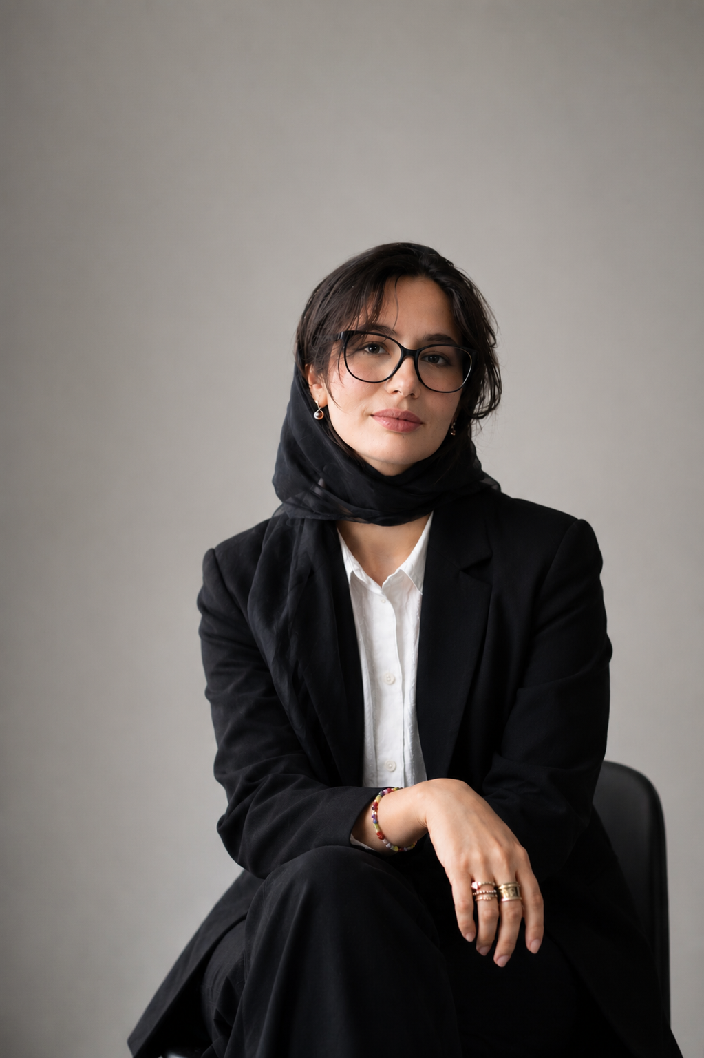 Portrait of author Narges Darweshi seated in a softly lit room.